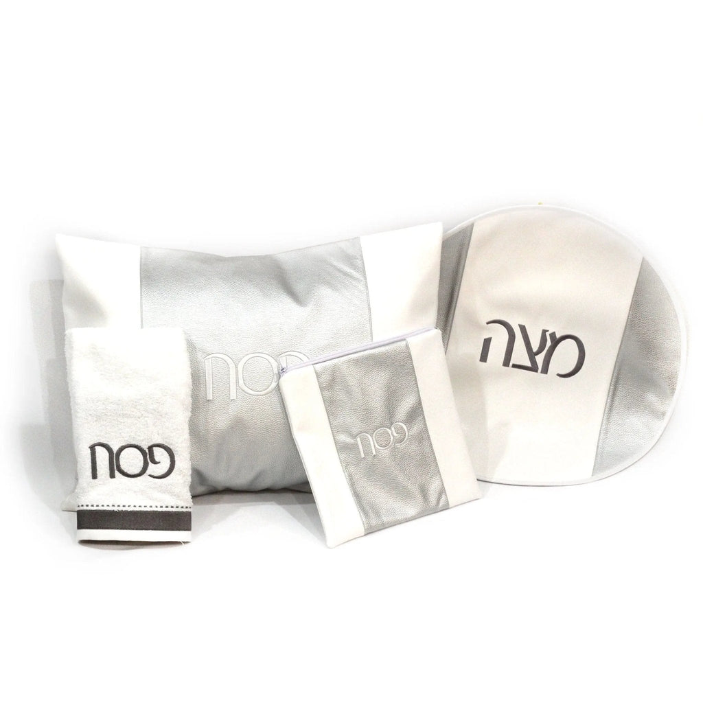White leather three sections Pesach set with silver accents and Hebrew text, displayed with coordinating tabletop pieces for holiday dining.