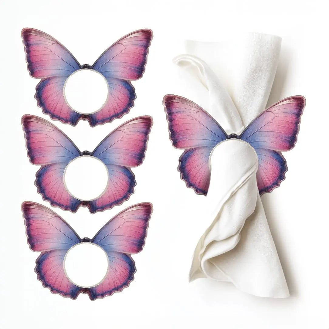 Tie-dye butterfly napkin rings in purple and pink with silver accents, set of three displayed with folded white napkin for table setting.