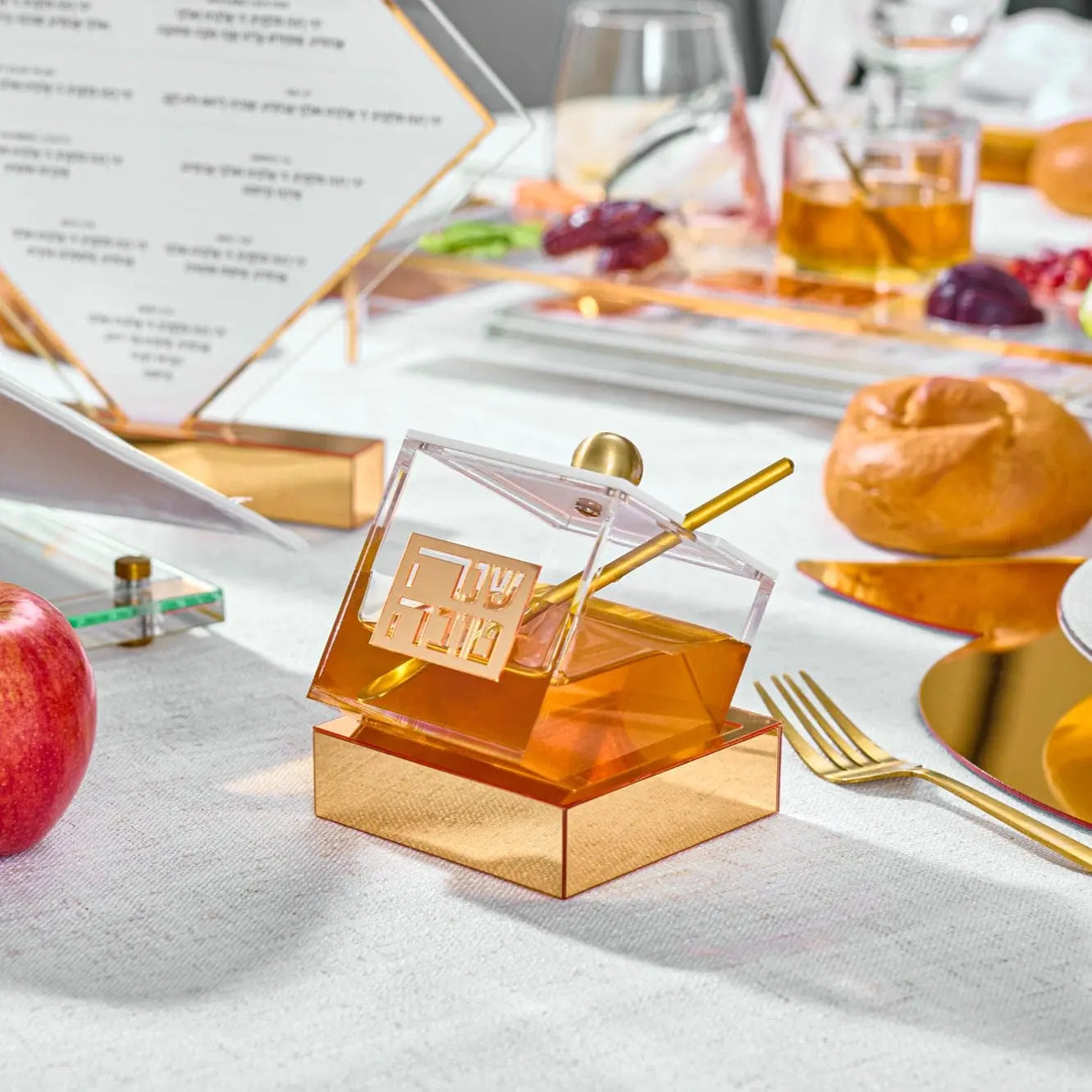 Amber glass Tilt Honey Dish by Waterdale Collection with geometric diamond pattern, displayed on white surface with honey and apple styling.