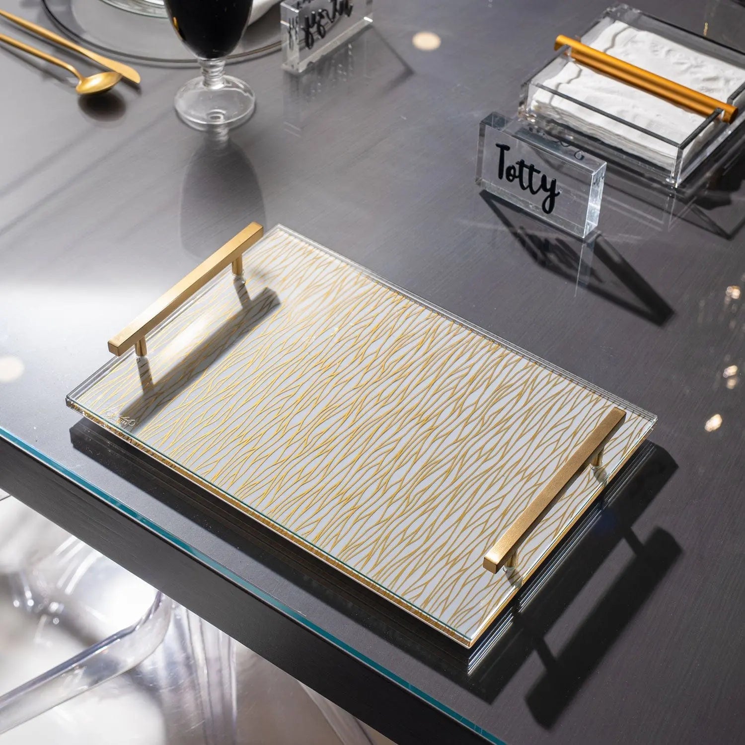 Wave Challah Board with silver handles on black tray, displayed in home tabletop setting with Shabbat items